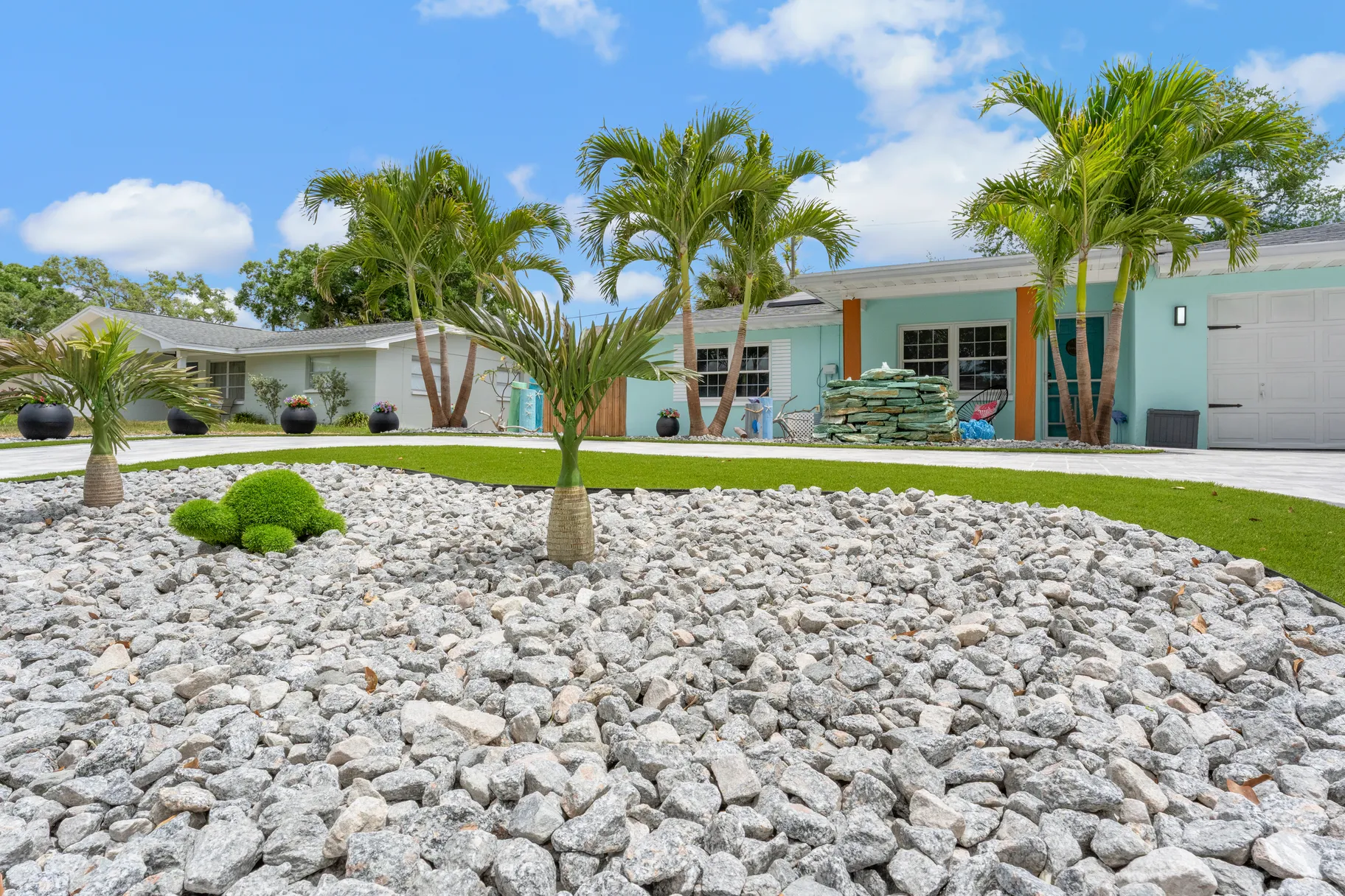 Paver driveway and landscaped entry at a coastal property